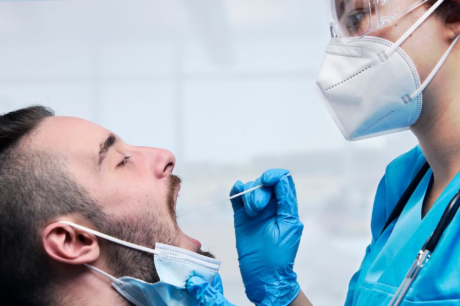Man being saliva tested in a lab